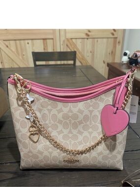 Coach Pink Trim Signature Canvas Shoulder Bag
CDQ14